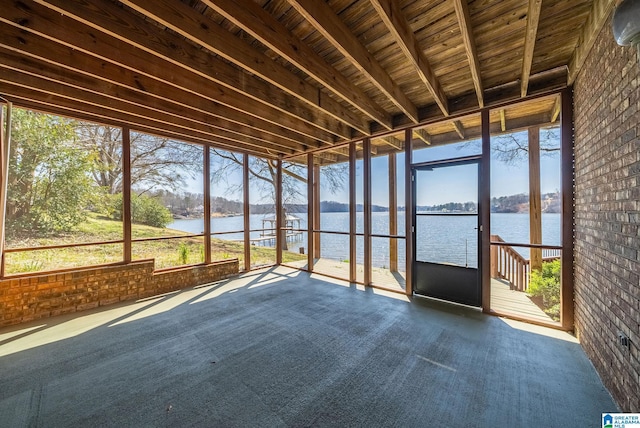 unfurnished sunroom with a water view