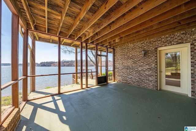 unfurnished sunroom with a water view and a wealth of natural light