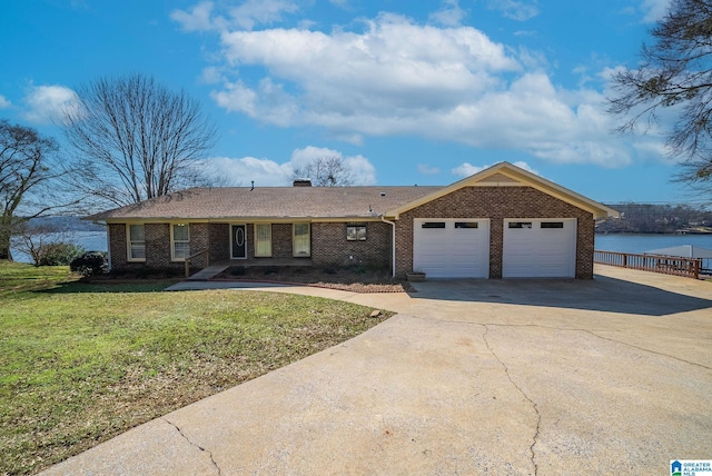 single story home with brick siding, a front lawn, concrete driveway, a chimney, and an attached garage