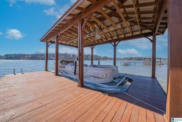 dock area featuring boat lift and a water view