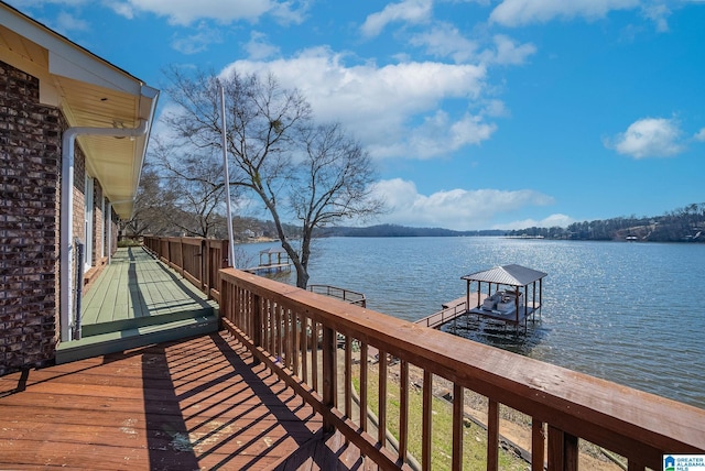 deck with boat lift, a boat dock, and a water view