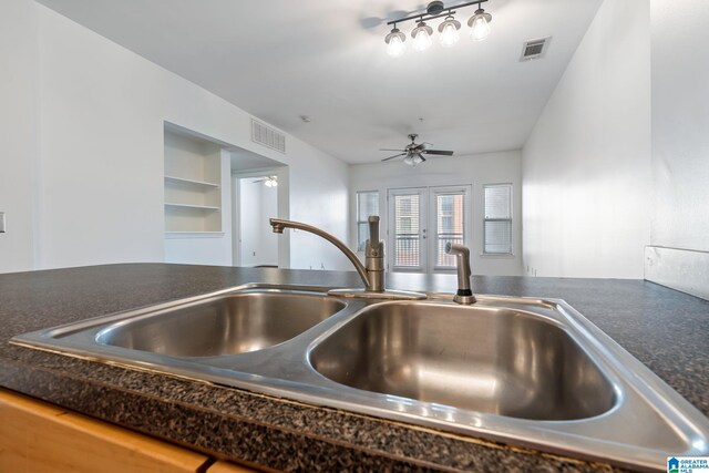 401 20th St S Unit 309, Birmingham, AL 35233 - interior details with ceiling fan, dark countertops, visible vents, and a sink