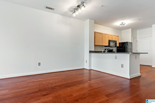 401 20th St S Unit 309, Birmingham, AL 35233 - kitchen featuring dark wood-style floors, baseboards, a peninsula, black appliances, and dark countertops