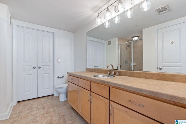 401 20th St S Unit 309, Birmingham, AL 35233 - full bath featuring vanity, visible vents, a shower stall, tile patterned floors, and toilet