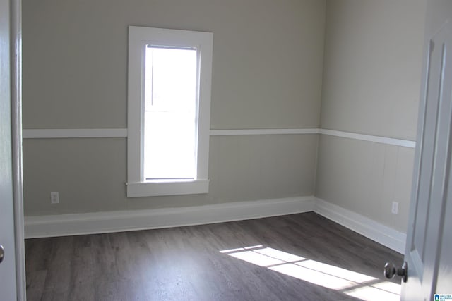 empty room with baseboards and wood finished floors