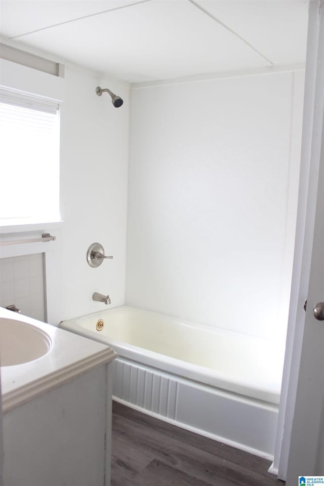 full bathroom with shower / bathtub combination, wood finished floors, and vanity