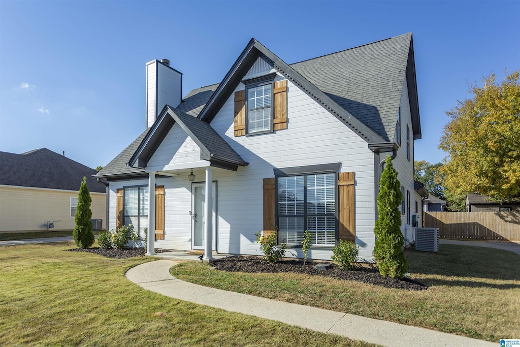 126 W Stonehaven Cir, Pelham, AL 35124 - view of front facade with roof with shingles, a chimney, a front lawn, and fence