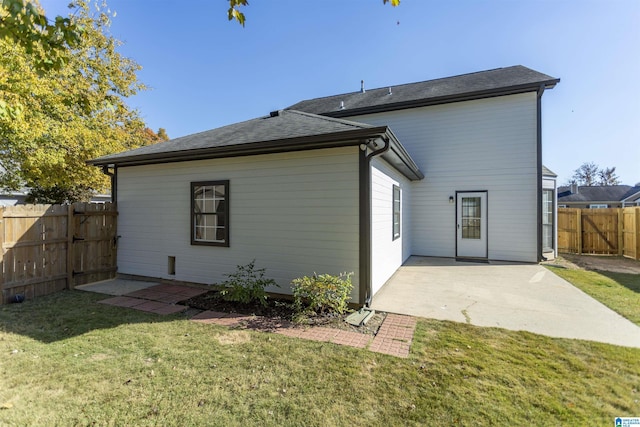 back of property featuring a fenced backyard, a lawn, and a patio