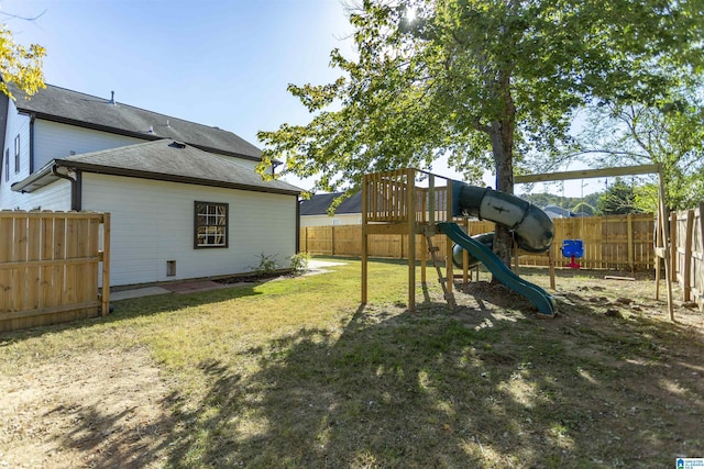 view of yard featuring a fenced backyard and a playground