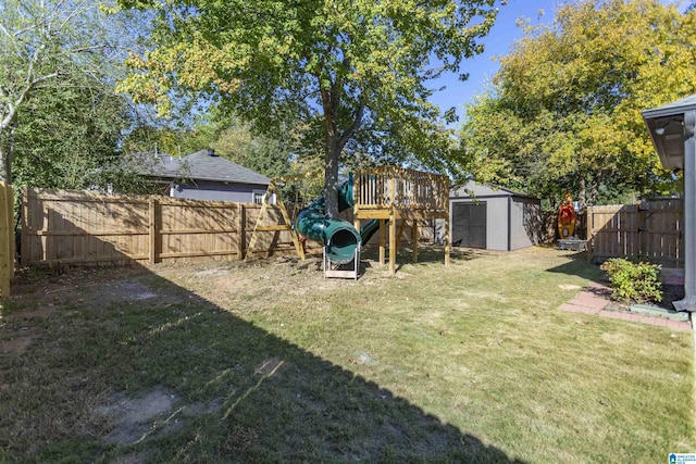 view of yard with a storage shed, a fenced backyard, and an outdoor structure