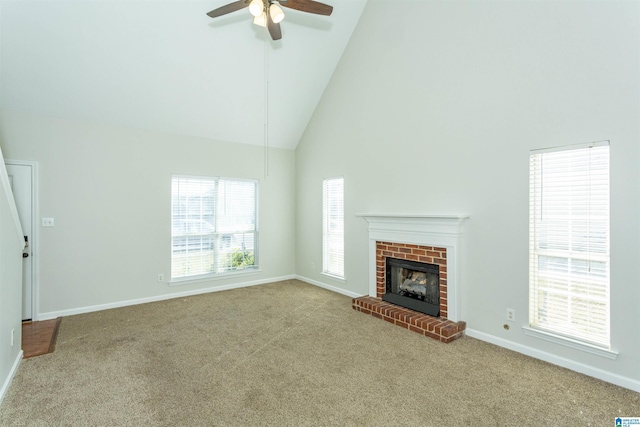 unfurnished living room with baseboards, high vaulted ceiling, ceiling fan, and carpet flooring