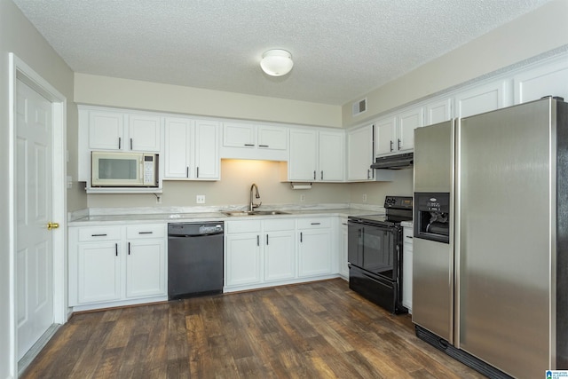 kitchen with under cabinet range hood, light countertops, white cabinets, black appliances, and a sink