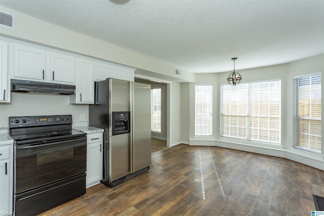 kitchen featuring under cabinet range hood, dark wood-style floors, black range with electric cooktop, stainless steel fridge, and light countertops