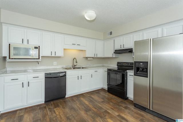 kitchen featuring visible vents, a sink, black appliances, dark wood-type flooring, and under cabinet range hood