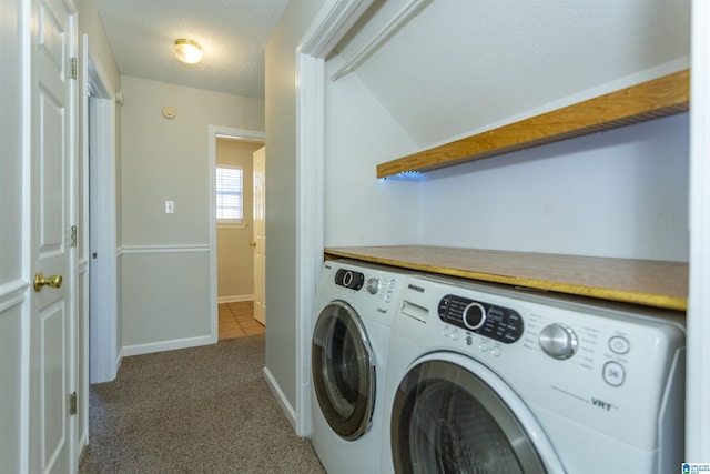 laundry area featuring washer and dryer, a textured ceiling, carpet flooring, baseboards, and laundry area