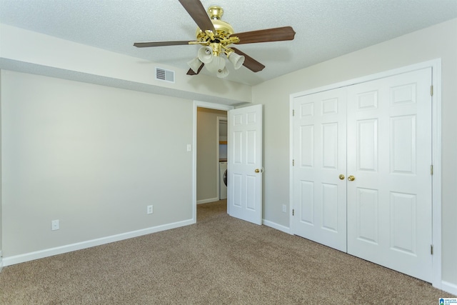 unfurnished bedroom featuring baseboards, visible vents, carpet floors, and a textured ceiling