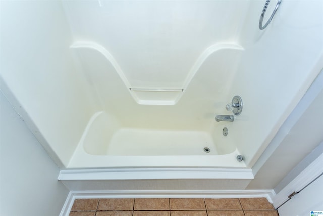 bathroom with tile patterned flooring and bathing tub / shower combination