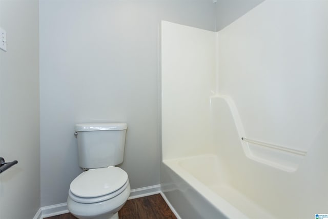 bathroom featuring walk in shower, baseboards, toilet, wood finished floors, and a bath