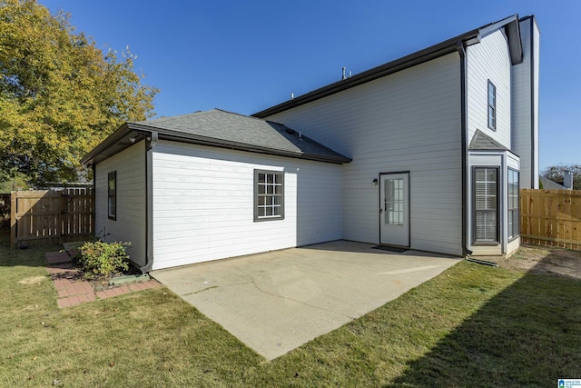 back of house with a patio, fence, and a lawn