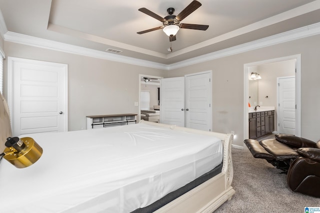 bedroom with visible vents, crown molding, a raised ceiling, and carpet floors