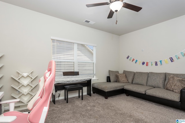 living room featuring carpet flooring, a ceiling fan, visible vents, and baseboards