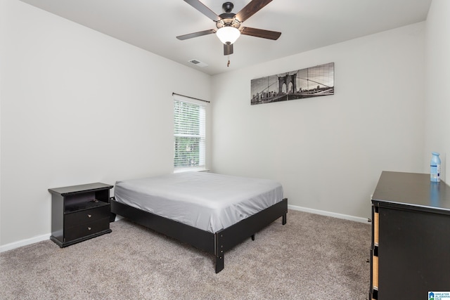 carpeted bedroom with visible vents, ceiling fan, and baseboards