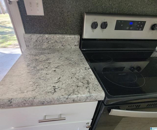 room details featuring stainless steel electric range oven and light countertops