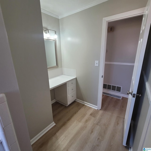 bathroom with visible vents, vanity, wood finished floors, and crown molding