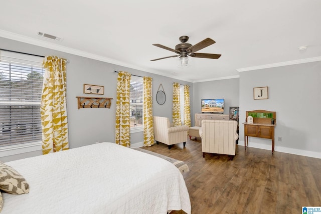 bedroom featuring visible vents, dark wood-type flooring, ornamental molding, baseboards, and ceiling fan