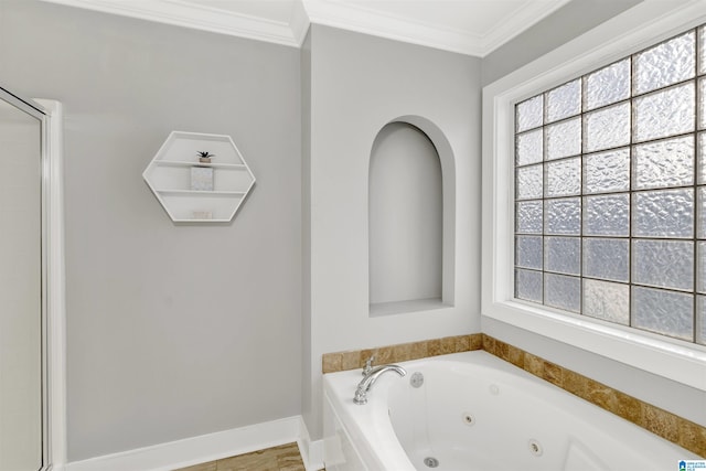 bathroom with a healthy amount of sunlight, a jetted tub, and ornamental molding