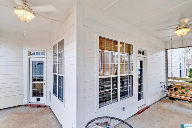 entrance to property with cooling unit, a porch, and a ceiling fan