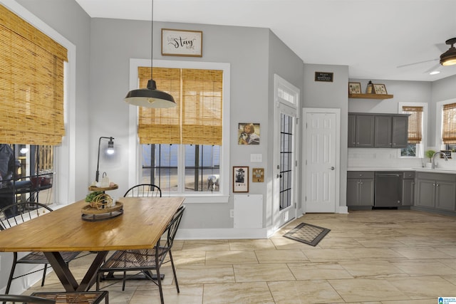 dining room featuring baseboards and ceiling fan