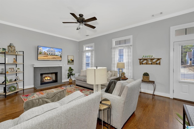 living area featuring visible vents, ornamental molding, ceiling fan, and dark wood-style flooring