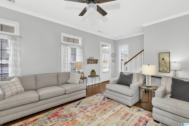 living area featuring a wealth of natural light, stairway, ceiling fan, and wood finished floors