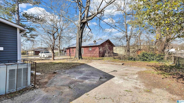 view of yard featuring central AC unit and fence