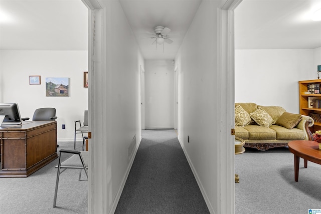 corridor with visible vents, baseboards, and carpet