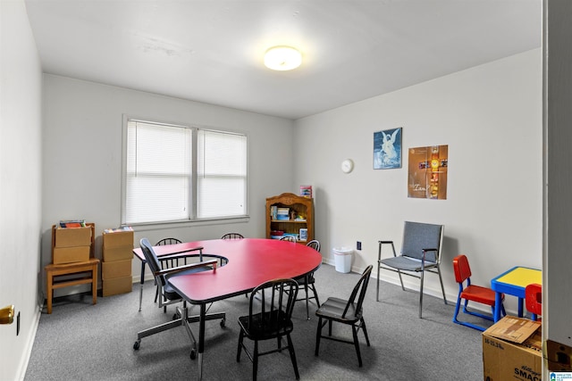 dining space featuring baseboards and carpet floors