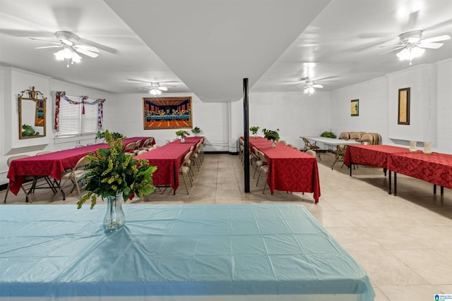 interior space with light tile patterned floors and ceiling fan