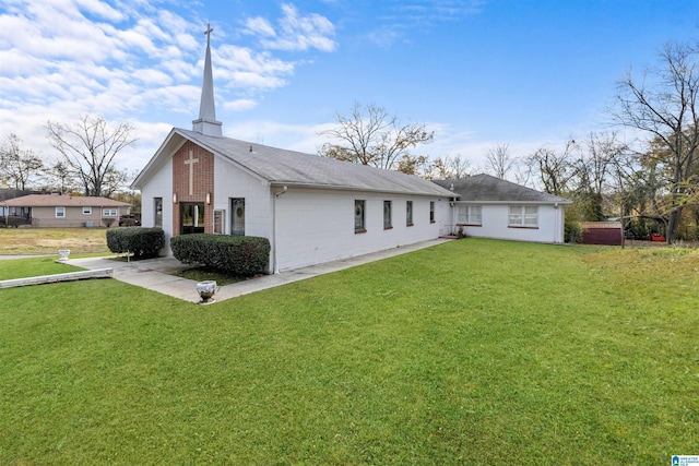 back of property featuring a yard