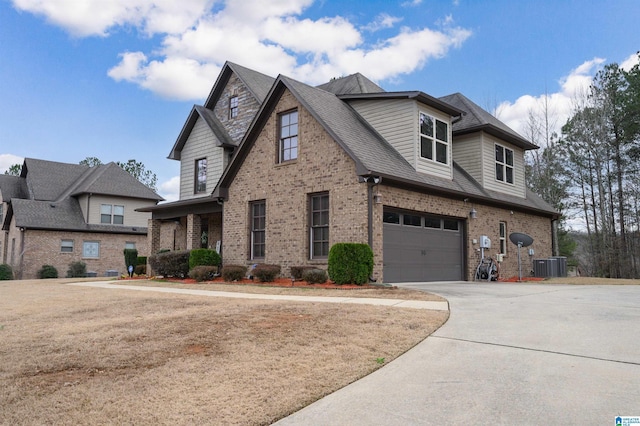 view of front of home with brick siding, central air condition unit, concrete driveway, roof with shingles, and a garage