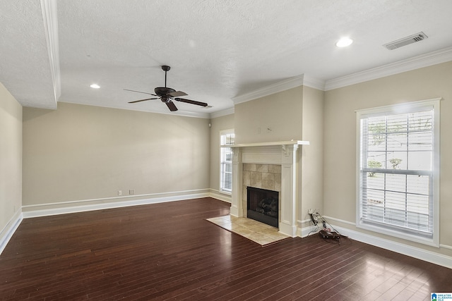 unfurnished living room featuring visible vents, baseboards, a tile fireplace, hardwood / wood-style flooring, and a ceiling fan