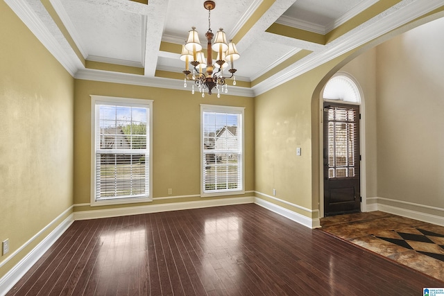 interior space with arched walkways, dark wood-type flooring, a chandelier, and coffered ceiling