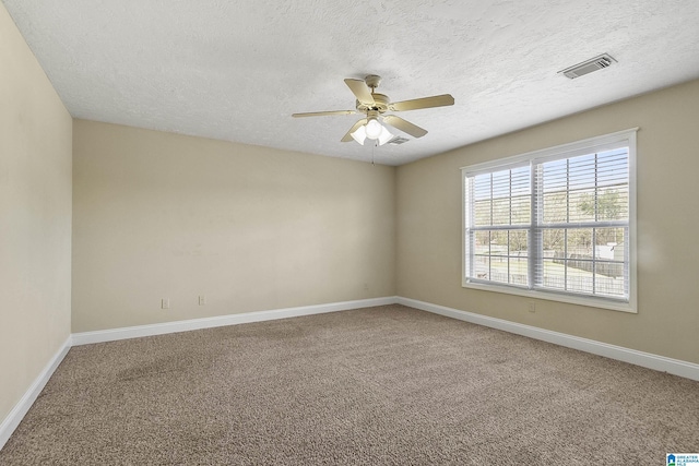 unfurnished room featuring visible vents, baseboards, ceiling fan, and carpet flooring