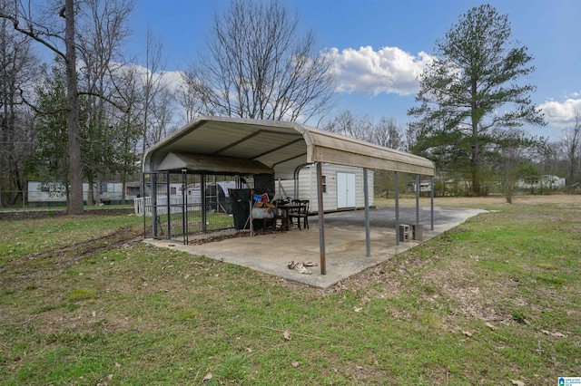 view of outbuilding featuring a carport and fence