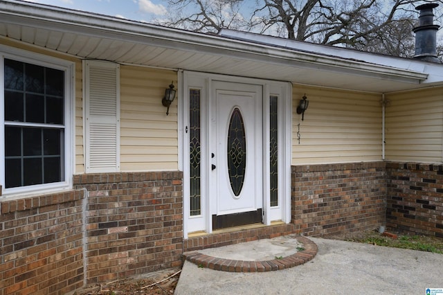 entrance to property with brick siding