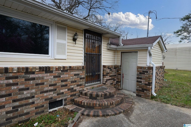 property entrance featuring brick siding