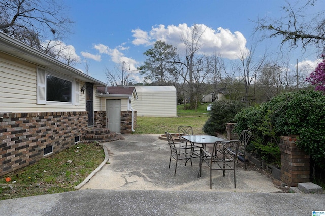 view of patio with an outbuilding and outdoor dining area