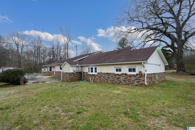 rear view of house featuring a yard and a patio area