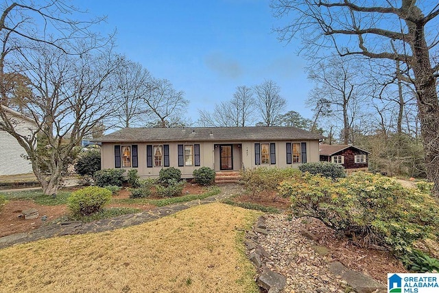 ranch-style house with stucco siding and a front lawn