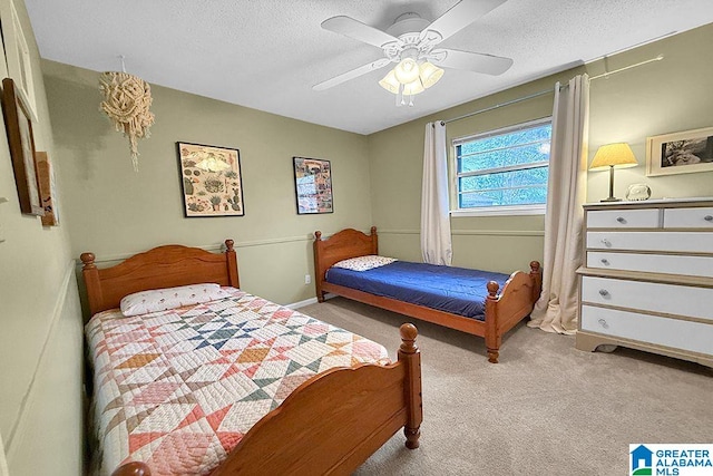 bedroom featuring baseboards, a textured ceiling, ceiling fan, and carpet flooring